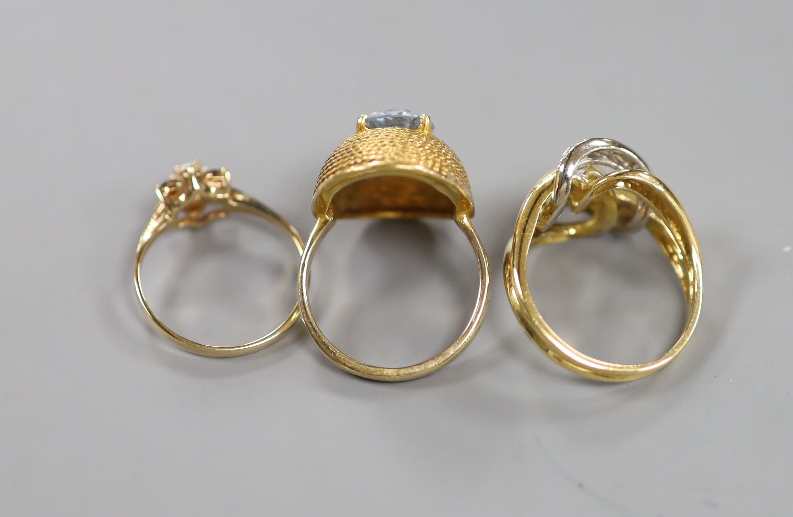 A modern 750 yellow metal and diamond chip set dress ring, size O, gross 6.6 grams and two other yellow metal and gem set rings, gross 7.3 grams.